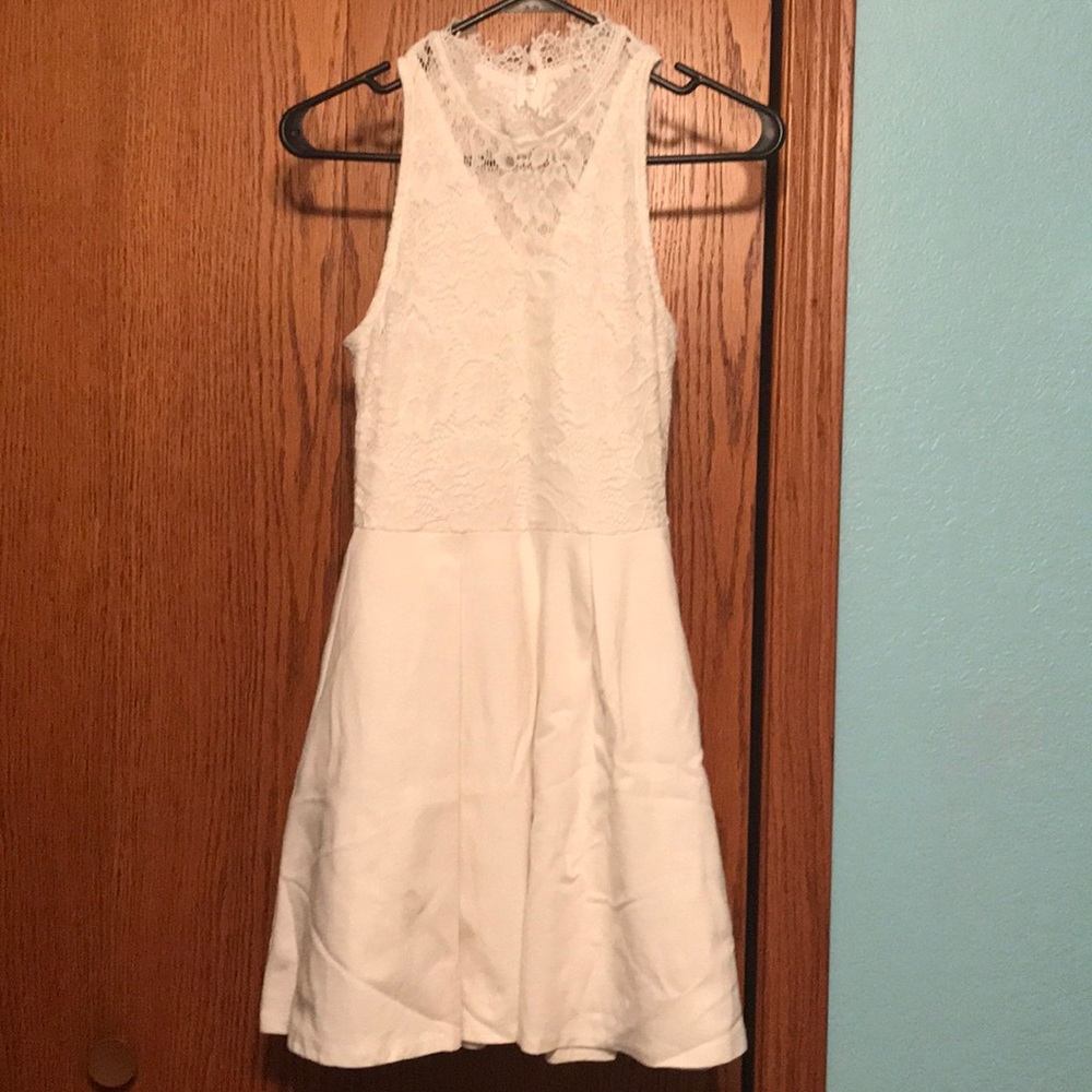White sleeveless dress with lace top.